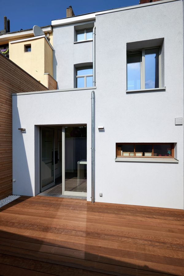 Construction of a new facade in courtyard  from old house before and after